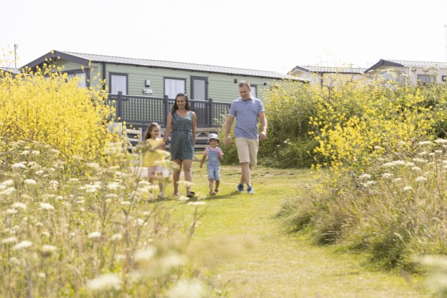 Family outside park home in Crantock Beach
