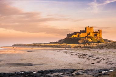 bamburgh castle sitting on a island