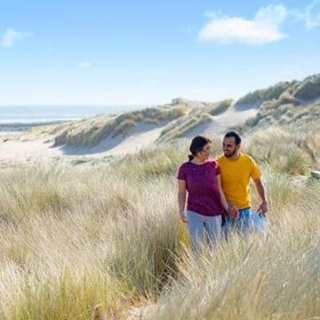 a couple going on a coastal walk
