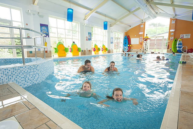 People swimming in the indoor swimming pool at Cresswell Towers Holiday Park