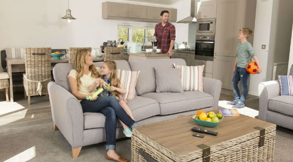 A family relaxing in their lodge living area