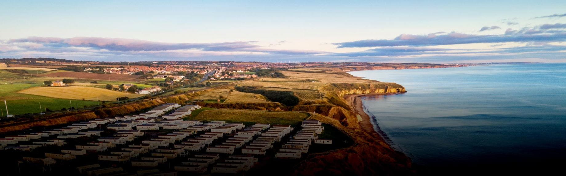 Coastal town and holiday park with views of the sea and miles of fields
