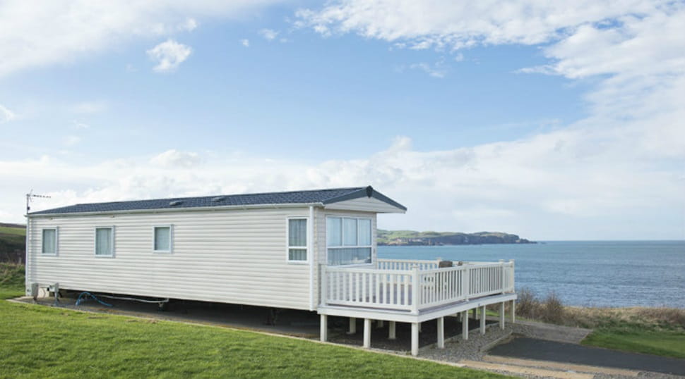 A caravan with a veranda overlooking the sea at Eyemouth Holiday Park