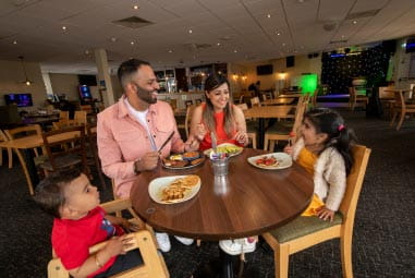 Family eating at a round table in a restaurant