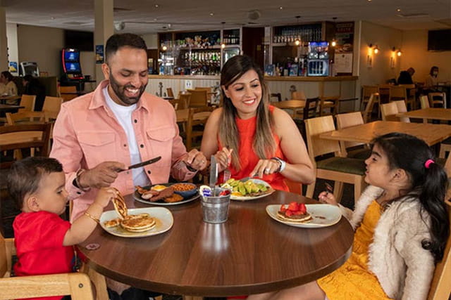 A family enjoying food and drinks in the restaurant