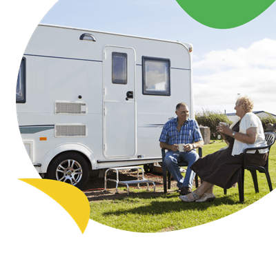 A couple sat outside their motorhome at Eyemouth Holiday Park
