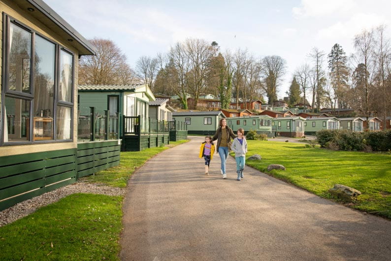 Family walking down a path in a holiday park