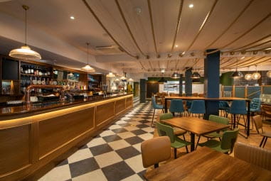 Restaurant with wooden bar and black and white checkered floor