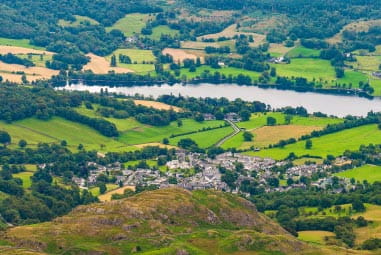 Green fields by a lake