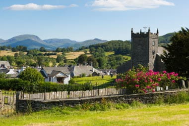 Picturesque village with cobbled lanes and historic buildings, surrounded by countryside