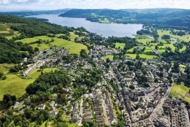 lakes, green fields and trees surrounding a small town