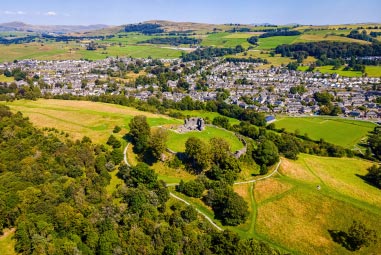 rolling green hills surrounding a small town