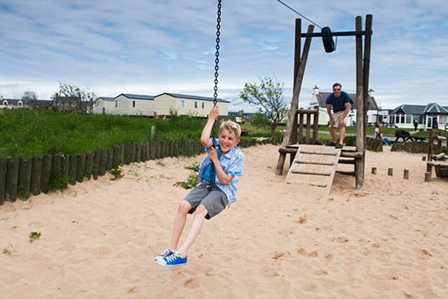 A boy on a zip wire at Grannie's Heilan Hame Holiday Park