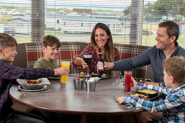 A family enjoying a meal in the restaurant