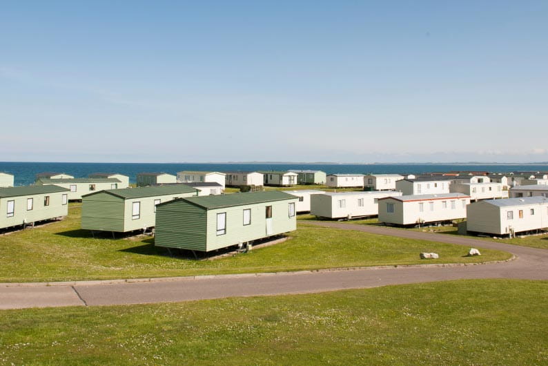 Rows of caravan accommodation sitting on green fields
