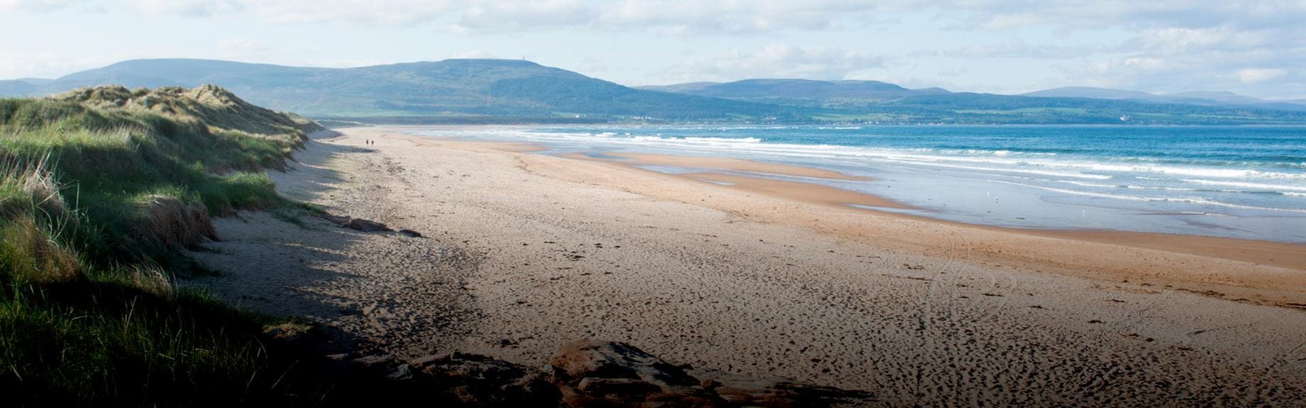 a large sandy beach stretching off into the horizon