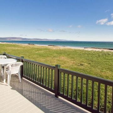 a picturesque view of the coast from over green fields