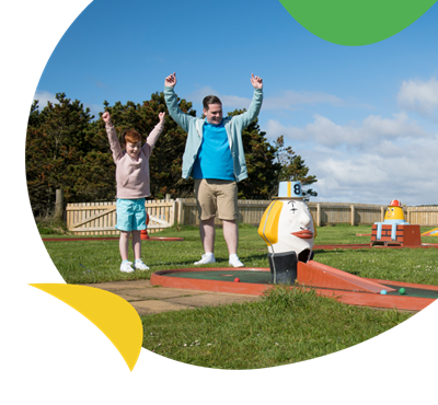 A family playing crazy golf at Grannie's Heilan Hame Holiday Park