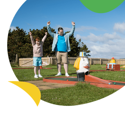A family playing crazy golf at Grannie's Heilan Hame Holiday Park