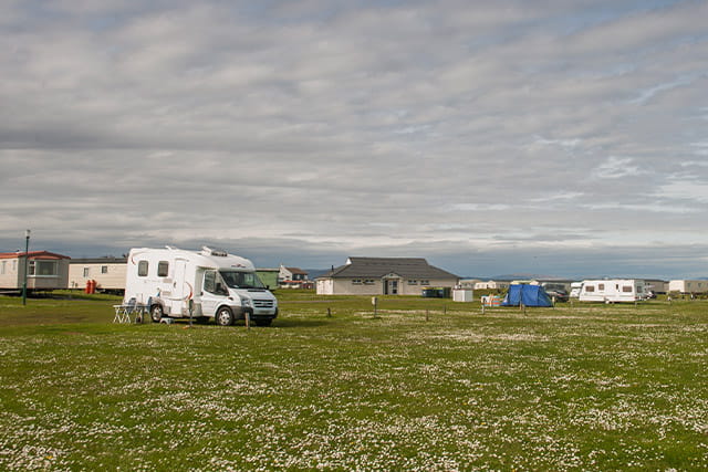 A motorhome and tents on the touring and camping site at Grannie's Heilan Hame Holiday Park
