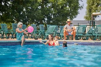 A family enjoying the outdoor swimming pool at Highfield Grange Holiday Park