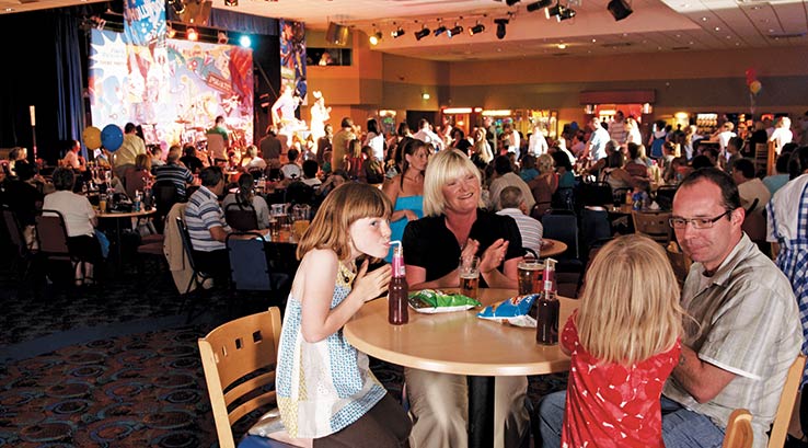 A family enjoying a meal in the live venue at Highfield Grange Holiday Park
