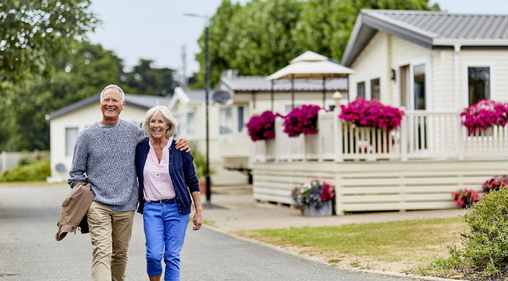 A couple strolling past the caravans on park at Highfield Grange