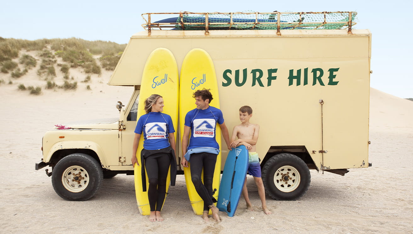 A surf hire van and instructors on the beach near Holywell Bay Holiday Park