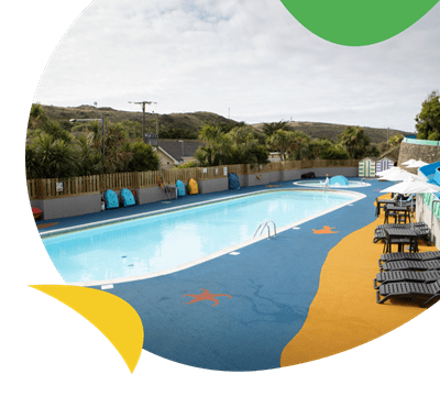 The outdoor heated swimming pool at Holywell Bay Holiday Park
