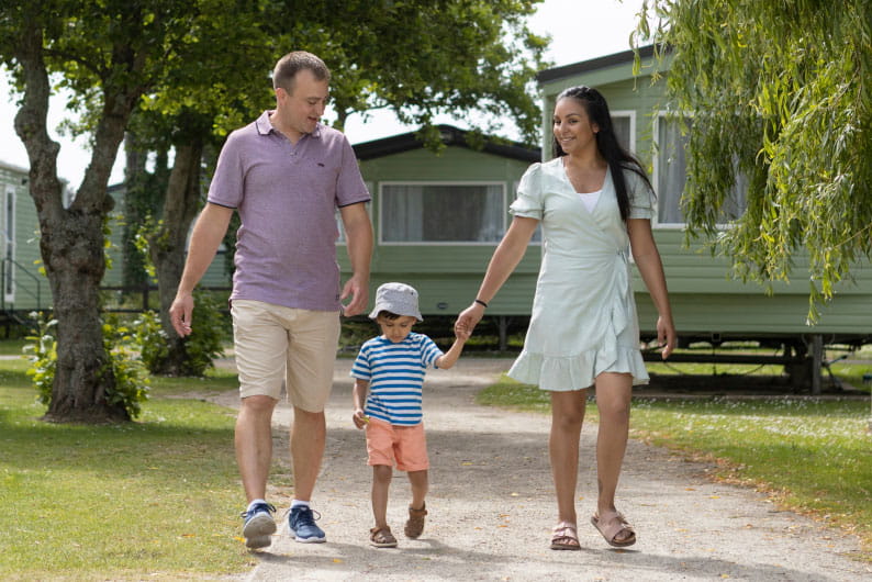 a family strolling though the holiday park