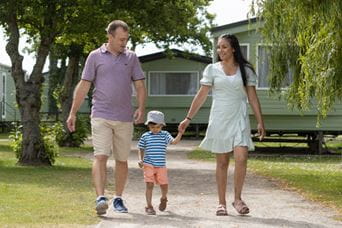 a family strolling though the holiday park