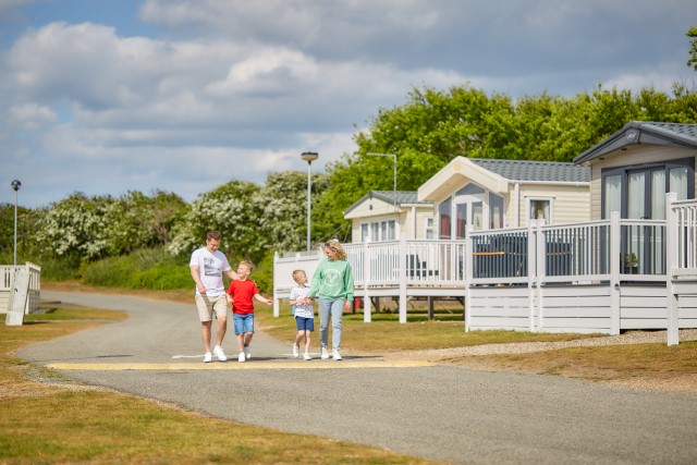 Family walking outside Kessingland Beach park home