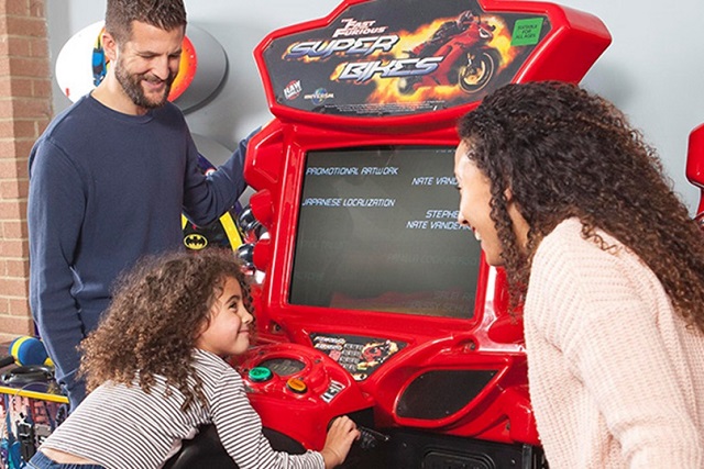 A family playing in the amusement arcade at Landguard Holiday Park