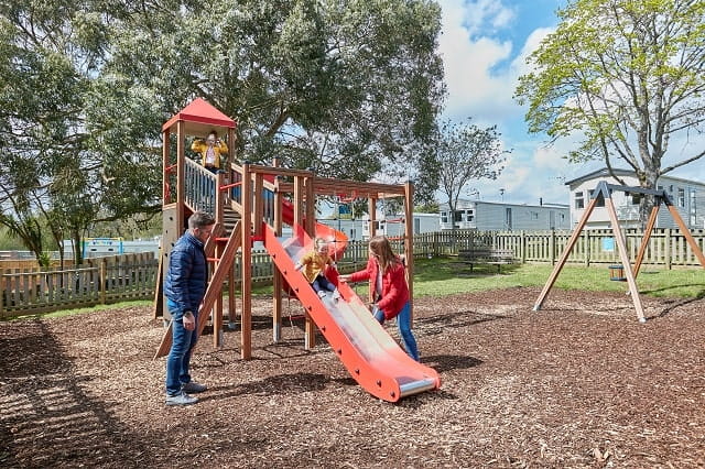 A family playing in the outdoor adventure playground at Landguard Holiday park