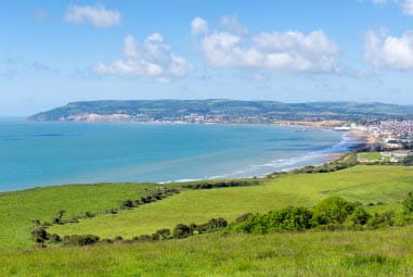 Rolling hills with the blue sea in the background