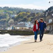 A couple taking a walk on a beach