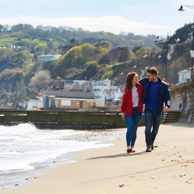 A couple taking a walk on a beach