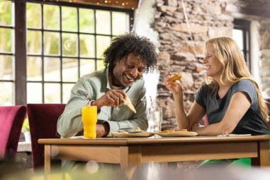a couple having a meal at the haybarn inn