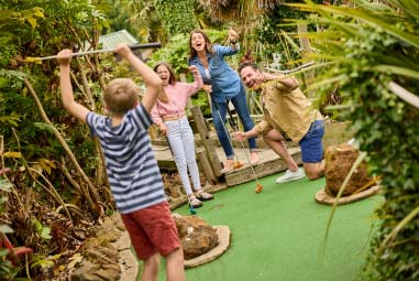 family playing adventure golf