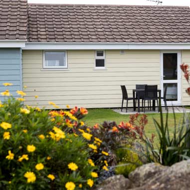 image of a bungalow with flowers outside