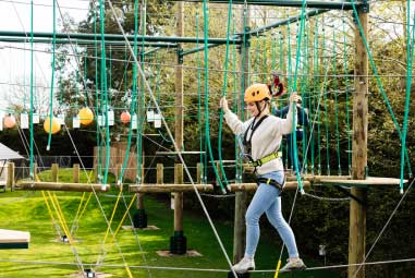 woman on outdoor high ropes