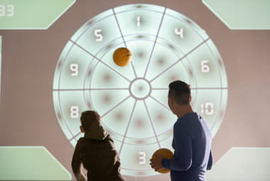 father and child playing on an interactive wall