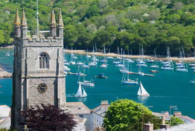 castle with sailboats on water