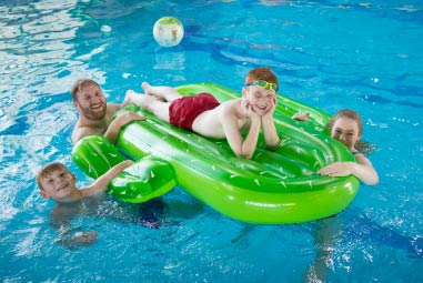 children on lilo in an indoor pool