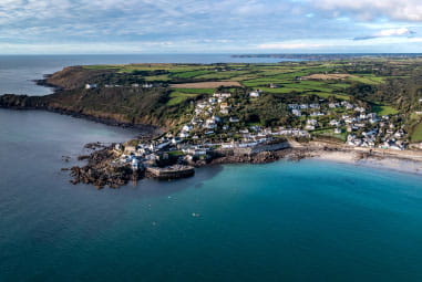 Coverack Cove, with deep blue water and picturesque bay