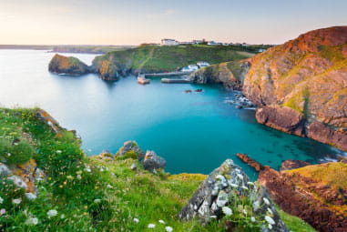 beautiful landscape picture of Mullion bay in the sunset