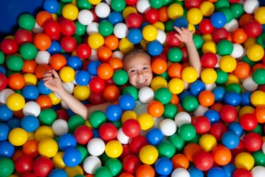 child in a ball pit