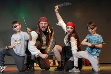 children posing with pirates