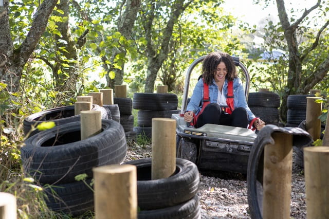Woman riding in the adventure bugz activity through a trail
