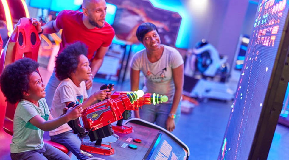 family playing indoor arcade games